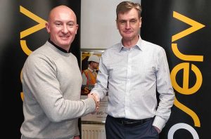 Davis Larsson, CSO at Proserv (left) and James Holt, VP Metering at SGC Metering, shake hands on the deal
